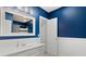 Stylish bathroom with blue walls, white wainscoting, and updated fixtures at 3819 S Waco St, Aurora, CO 80013