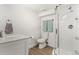 Bright bathroom features a shower with glass doors, a toilet and vanity with a marble countertop at 3819 S Waco St, Aurora, CO 80013