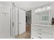 Bathroom with a marble top vanity, white cabinets, a glass shower and tile flooring at 3819 S Waco St, Aurora, CO 80013