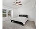 Bedroom with ceiling fan, plush carpet, and natural light at 3819 S Waco St, Aurora, CO 80013