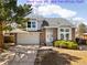 Charming two-story home with a well-manicured lawn, brick accents, and an attached two-car garage at 3819 S Waco St, Aurora, CO 80013