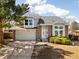 Charming two-story home with a well-manicured lawn, brick accents, and an attached two-car garage at 3819 S Waco St, Aurora, CO 80013