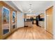 Open kitchen and dining area with wood floors and french doors to the exterior deck at 3819 S Waco St, Aurora, CO 80013