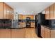 Updated kitchen with granite countertops, stainless steel appliances, and wooden cabinets at 3819 S Waco St, Aurora, CO 80013