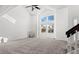 Bright living room features a high ceiling, large windows, and new carpet at 3819 S Waco St, Aurora, CO 80013