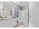 Well-lit bathroom featuring a granite-topped vanity, bathtub, and a neutral color palette at 10819 Summerset Way, Parker, CO 80138