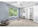 Cozy bedroom with large window, built-in shelving, closet, and neutral carpet at 10819 Summerset Way, Parker, CO 80138