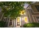 Charming townhome with a well-maintained front yard and inviting entrance with warm lights at 10819 Summerset Way, Parker, CO 80138