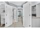Bright hallway with multiple doorways, open closet space, and neutral carpeting at 10819 Summerset Way, Parker, CO 80138