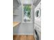 Practical laundry area with a window, washer, dryer, and shelving for organized storage at 10819 Summerset Way, Parker, CO 80138