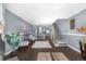 Bright living room with hardwood floors, an open floor plan, and access to the staircase at 10819 Summerset Way, Parker, CO 80138