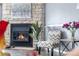 Cozy living room showcasing a stone fireplace, comfortable seating, and hardwood floors at 10819 Summerset Way, Parker, CO 80138