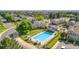 Aerial view of a community pool surrounded by lounge chairs and well-maintained landscaping at 10819 Summerset Way, Parker, CO 80138
