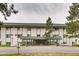 Multi-Gathering building with green awning, white walls, and green trim at 8824 E Florida Ave # 103, Denver, CO 80247