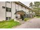 This exterior shows an inviting building entrance with well-maintained landscaping at 8824 E Florida Ave # 103, Denver, CO 80247