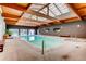 Bright indoor pool with skylights, light stone and wood accents at 8824 E Florida Ave # 103, Denver, CO 80247