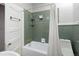 Bathroom with retro green tiling, a shower and bathtub combo, and modern fixtures at 3391 W 32Nd Ave, Denver, CO 80211