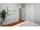 Bedroom with hardwood floors, artwork, and white trim at 3391 W 32Nd Ave, Denver, CO 80211