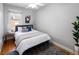 Bedroom with hardwood floors, ceiling fan, and a comfortable bed with decorative pillows at 3391 W 32Nd Ave, Denver, CO 80211