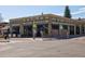 Exterior view of Three Dogs Tavern at street-level, with a large corner sign at 3391 W 32Nd Ave, Denver, CO 80211