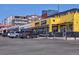 Street-level view of shopping center featuring various businesses along the street at 3391 W 32Nd Ave, Denver, CO 80211
