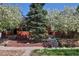 Charming brick home featuring blooming trees and a well-manicured lawn at 3391 W 32Nd Ave, Denver, CO 80211