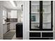 Charming kitchen featuring white cabinets, stainless steel appliances, and a black glass doored cabinet at 3391 W 32Nd Ave, Denver, CO 80211