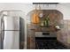 Kitchen featuring stone tile, stainless steel fridge and stove top at 3391 W 32Nd Ave, Denver, CO 80211