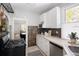 Bright kitchen featuring stainless appliances, tile backsplash, and a view into the dining and living rooms at 3391 W 32Nd Ave, Denver, CO 80211