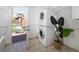 Charming laundry room with stacked washer and dryer leading to back patio at 3391 W 32Nd Ave, Denver, CO 80211