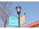 Welcome sign for Highland Square with street lamp and bare trees in background at 3391 W 32Nd Ave, Denver, CO 80211