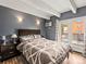 Comfortable bedroom featuring wood floors, balcony access, and neutral decor at 100 S Clarkson St # 202, Denver, CO 80209