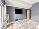 Bedroom featuring neutral walls, white beams, and a mounted TV at 100 S Clarkson St # 202, Denver, CO 80209
