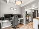 Kitchen with granite counters, white cabinets, and stainless appliances is adjacent to living space at 100 S Clarkson St # 202, Denver, CO 80209