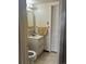 Cozy bathroom featuring a single sink vanity and a towel rack next to a white door at 938 Racine St, Aurora, CO 80011