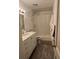 Bathroom featuring a white vanity with a marble countertop and a shower-tub combination at 938 Racine St, Aurora, CO 80011