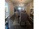 Well-lit dining room with a chandelier and view into the living room at 938 Racine St, Aurora, CO 80011