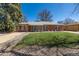 Charming brick home features a well-manicured lawn and classic architectural details at 938 Racine St, Aurora, CO 80011