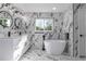 Elegant bathroom with marble accents, a freestanding tub, and a double sink vanity at 190 Hemlock St, Broomfield, CO 80020