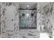 Elegant bathroom featuring marble tile, sleek shower, and modern fixtures at 190 Hemlock St, Broomfield, CO 80020