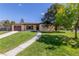 Charming one-story home with a well-manicured lawn, a concrete walkway, and a brown garage door at 190 Hemlock St, Broomfield, CO 80020