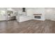 Open-concept living room featuring wood floors, a modern fireplace, and an updated kitchen at 190 Hemlock St, Broomfield, CO 80020
