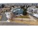 Aerial view showcasing the townhouse with a well-manicured lawn, patio, and mature trees in a quiet neighborhood at 4674 Flower St, Wheat Ridge, CO 80033