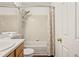 Cozy full bathroom with a shower-tub combo and tiled walls at 4674 Flower St, Wheat Ridge, CO 80033