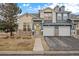 Charming townhome with a stone facade, attached garage, and well-maintained landscaping in a desirable neighborhood at 4674 Flower St, Wheat Ridge, CO 80033