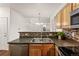 Kitchen featuring wooden cabinets, stainless appliances, and a convenient layout open to the adjacent living and dining area at 4674 Flower St, Wheat Ridge, CO 80033