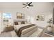 Bright main bedroom with a ceiling fan, light-colored walls, and neutral decor at 4674 Flower St, Wheat Ridge, CO 80033