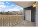 Cozy covered patio with a white picket fence and view of the surrounding neighborhood at 4674 Flower St, Wheat Ridge, CO 80033