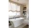 Spa-like bathroom with freestanding tub and elegant chandelier at 335 Clayton St, Denver, CO 80206