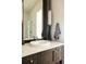 Modern bathroom with dark vanity and updated fixtures at 335 Clayton St, Denver, CO 80206